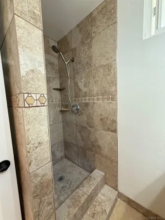 a bathroom with a toilet and a mirror