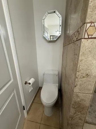 a bathroom with a toilet and a shower