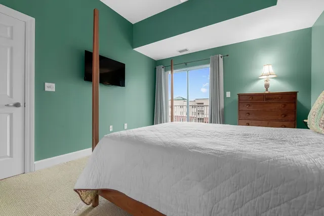 a bed room with a bed and a chair