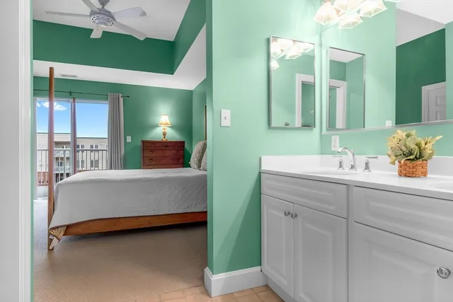 a spacious bathroom with a mirror sink and vanity