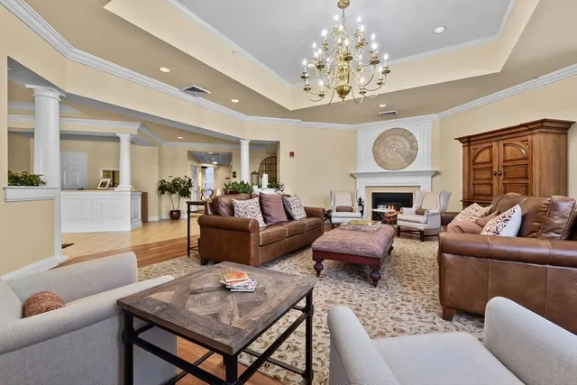 a living room with furniture and a chandelier