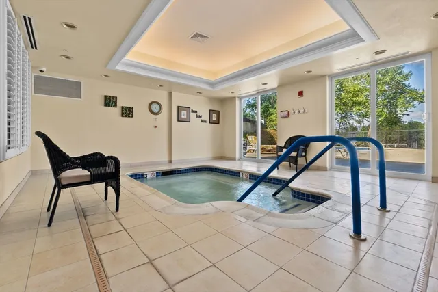 a living room with furniture and large windows