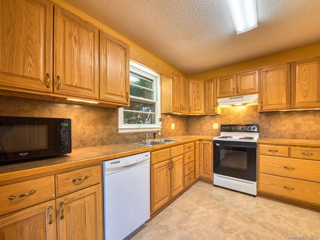 265 Shadow Ridge Sylva, NC 28779 - Photo 17 of 33 a kitchen with granite countertop cabinets stainless steel appliances and a window