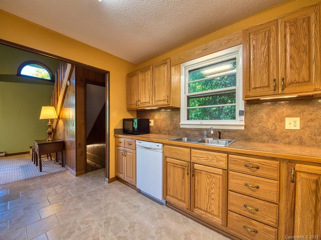 265 Shadow Ridge Sylva, NC 28779 - Photo 18 of 33 a kitchen with stainless steel appliances granite countertop a sink a stove and a refrigerator