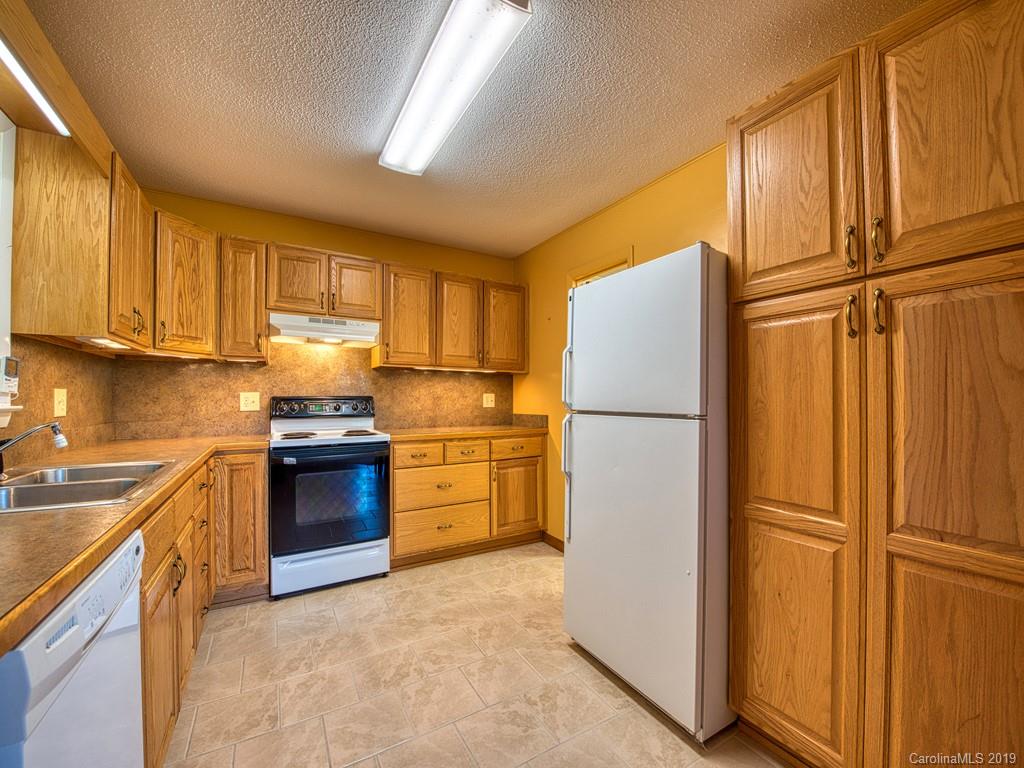 265 Shadow Ridge Sylva, NC 28779 - Photo 19 of 33 a kitchen with granite countertop stainless steel appliances and refrigerator