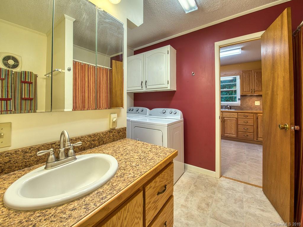 265 Shadow Ridge Sylva, NC 28779 - Photo 21 of 33 a bathroom with a granite countertop sink a mirror and a shower