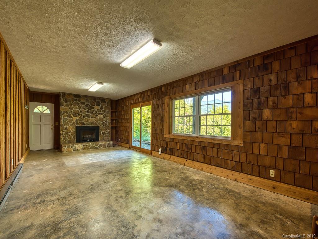 265 Shadow Ridge Sylva, NC 28779 - Photo 31 of 33 a view of an empty room with a fireplace and a window