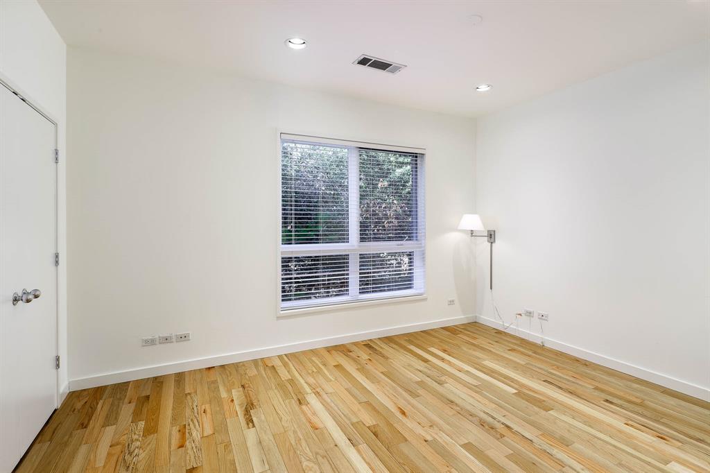 2910 Woodside Street Dallas, TX 75204 - Photo 14 of 24 a view of empty room with wooden floor and fan