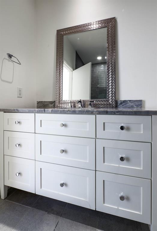 2910 Woodside Street Dallas, TX 75204 - Photo 16 of 24 a bathroom with white cabinets
