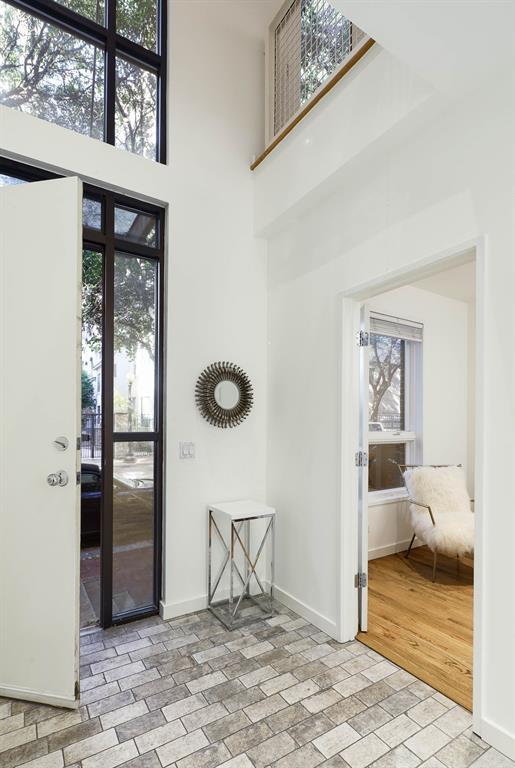 2910 Woodside Street Dallas, TX 75204 - Photo 6 of 24 a view of a livingroom with wooden floor and a ceiling fan