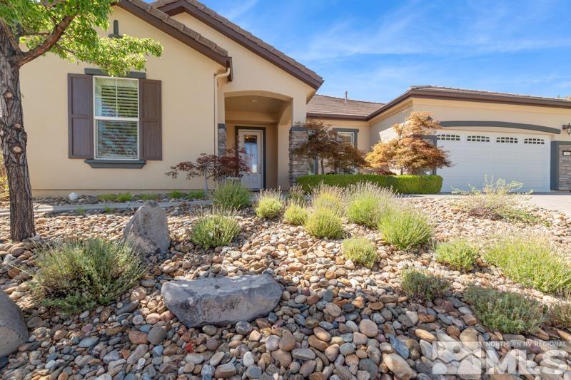 1555 Meridian Ranch Drive Reno, NV 89523 - Photo 3 of 39 a front view of a house with garden