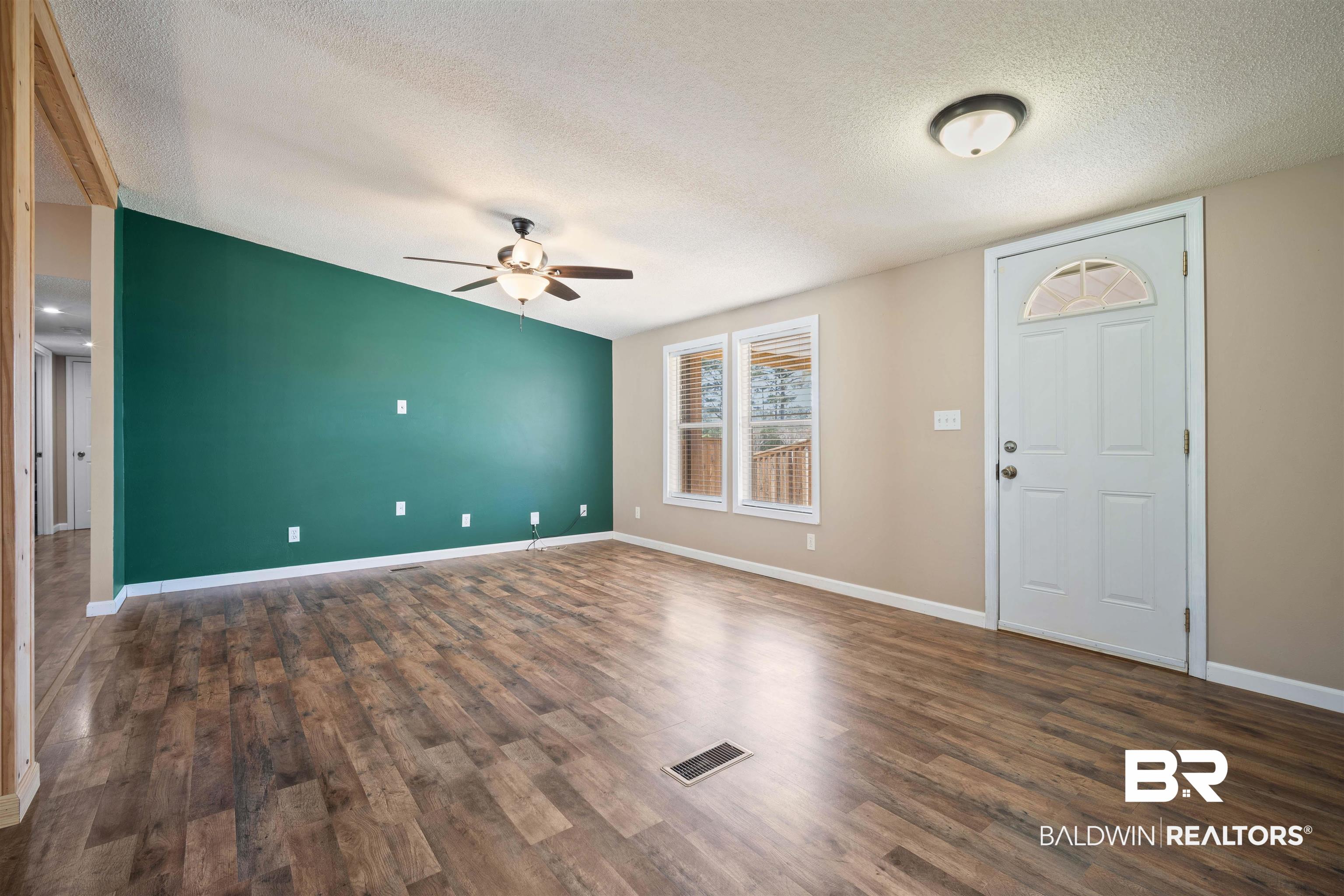 9011 Wilmer Georgetown Road Wilmer, AL 36587 - Photo 6 of 34 Entryway featuring a ceiling fan, a textured ceiling, baseboards, and wood finished floors