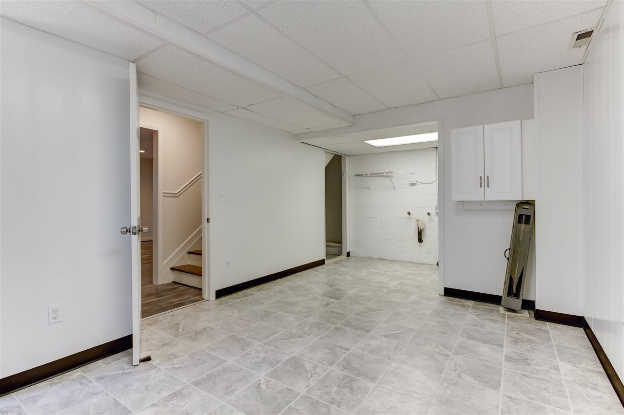 5205 Fieldstone Drive Raleigh, NC 27609 - Photo 12 of 13 This is a large basement room, which includes laundry area, commode, and slop sink. Also, significant open space and an exterior door. Laundry