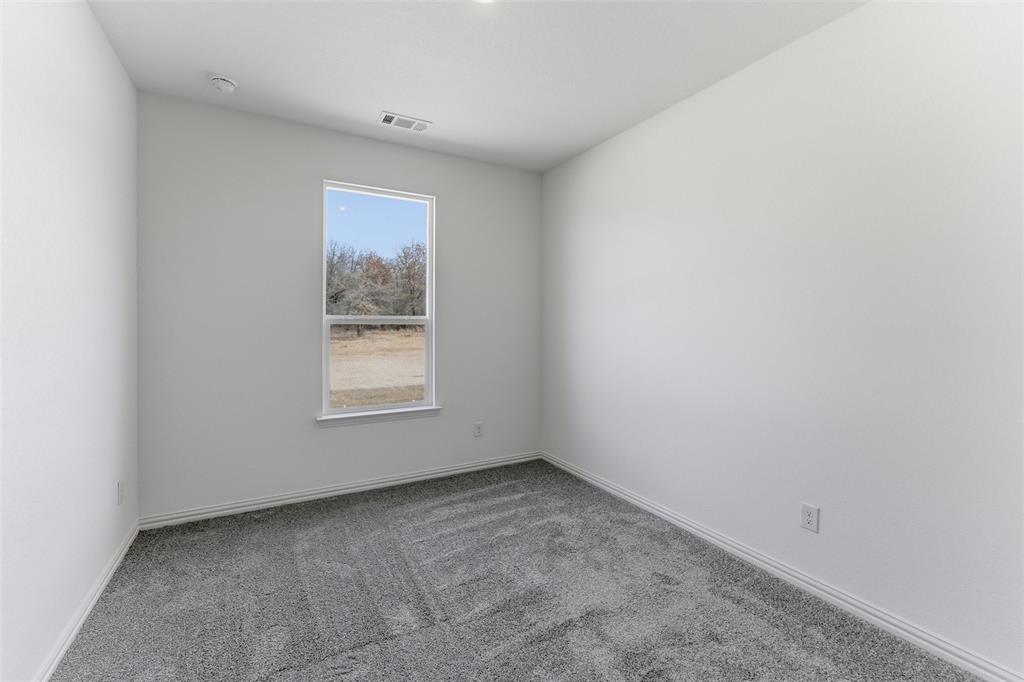 144 Oak Grv Way Springtown, TX 76082 - Photo 18 of 27 an empty room with a window