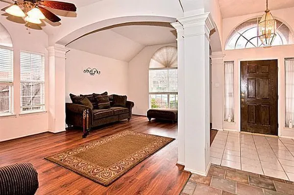 a living room with furniture rug and a window