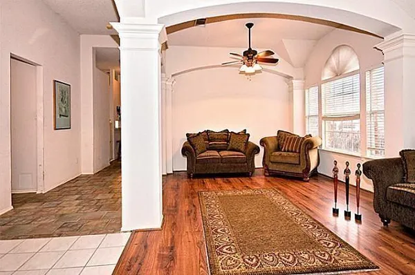 a living room with furniture rug and window