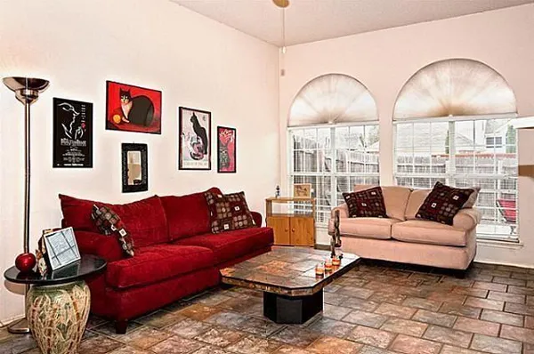 a living room with furniture a rug and white walls