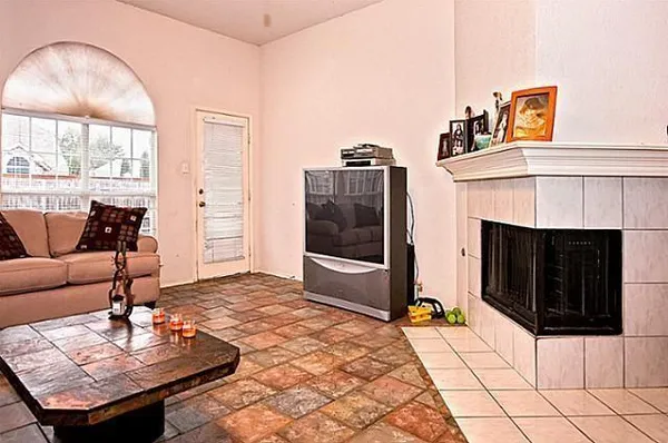 a living room with furniture and a fireplace