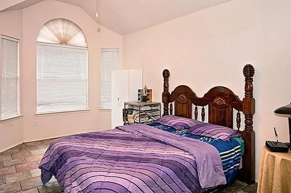 a bedroom with a bed and a window