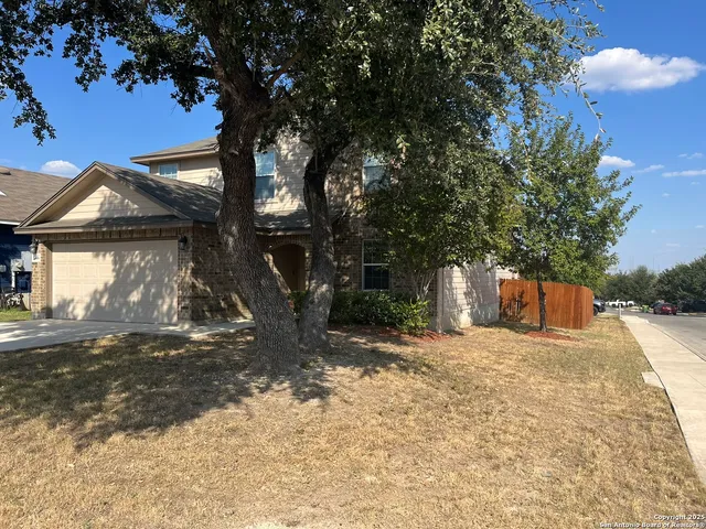 a view of a house with a tree and yard