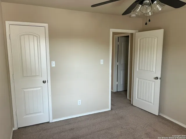 a view of an empty room with a mirror