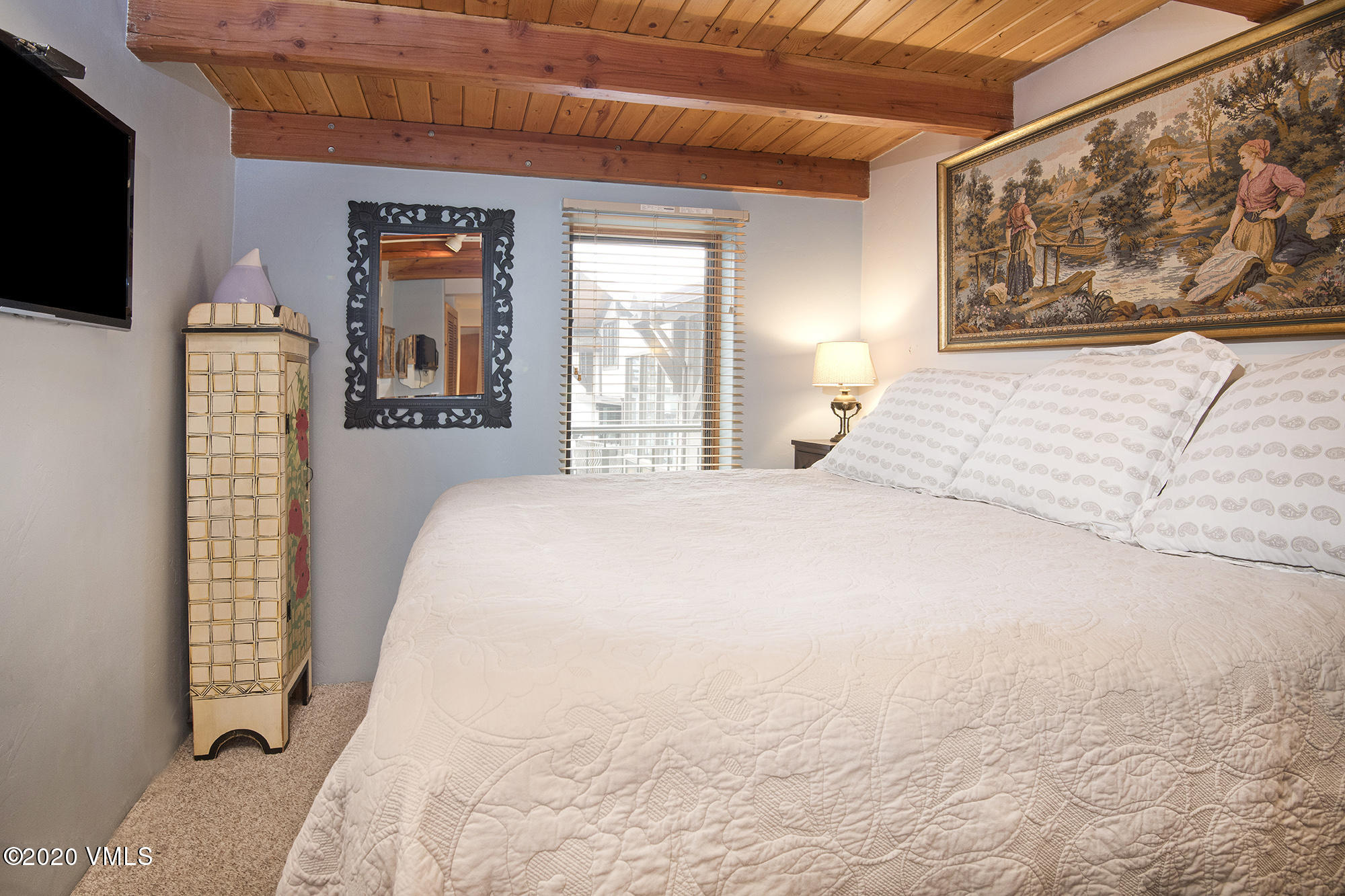 225 Wall Street, Unit 307 Vail, CO 81657 - Photo 12 of 31 a bedroom with a bed and a flat screen tv