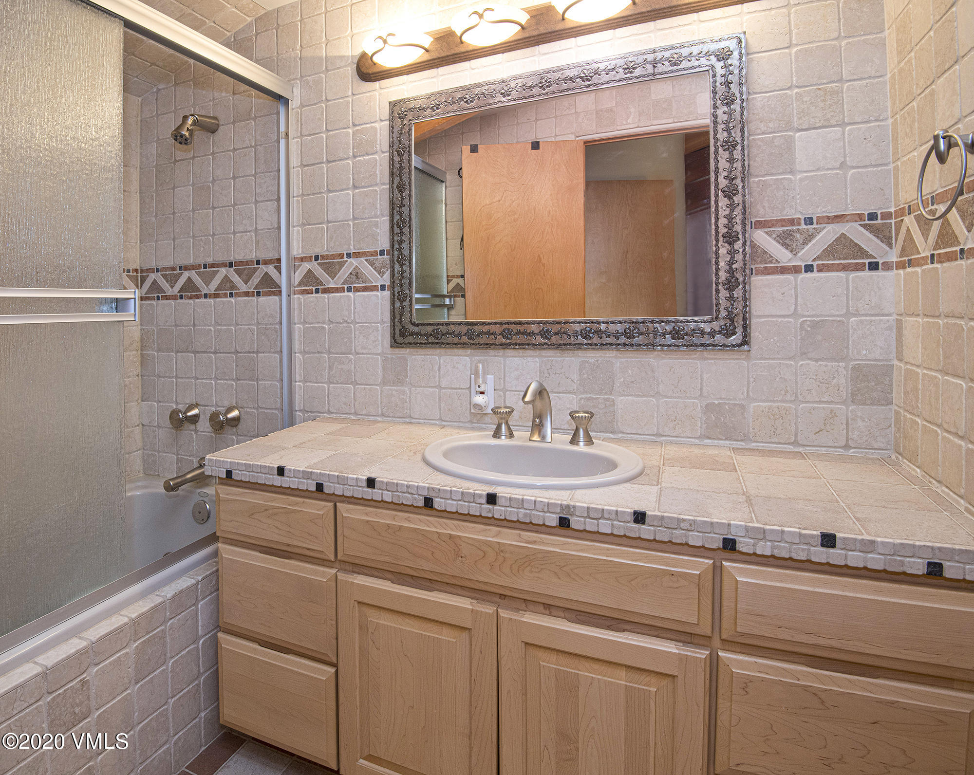 225 Wall Street, Unit 307 Vail, CO 81657 - Photo 19 of 31 a bathroom with a granite countertop sink and a mirror