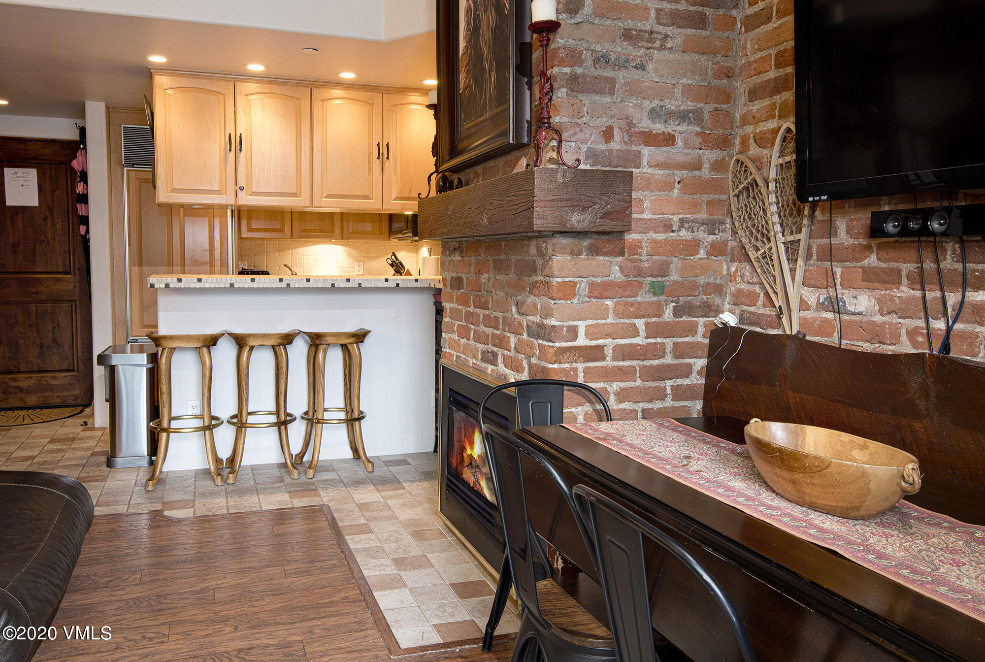 225 Wall Street, Unit 307 Vail, CO 81657 - Photo 4 of 31 a dining room with granite countertop a stove and a wooden floor
