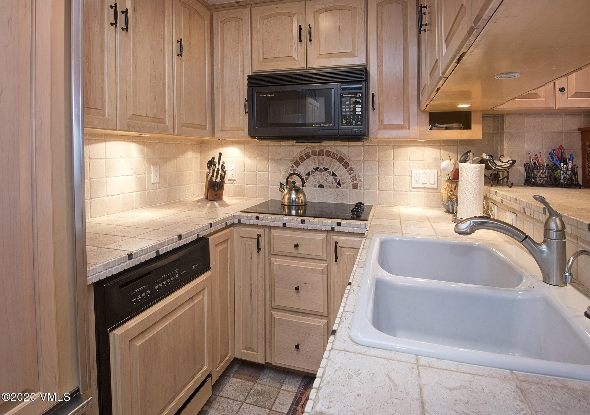 225 Wall Street, Unit 307 Vail, CO 81657 - Photo 7 of 31 a kitchen with granite countertop a sink stove and cabinets