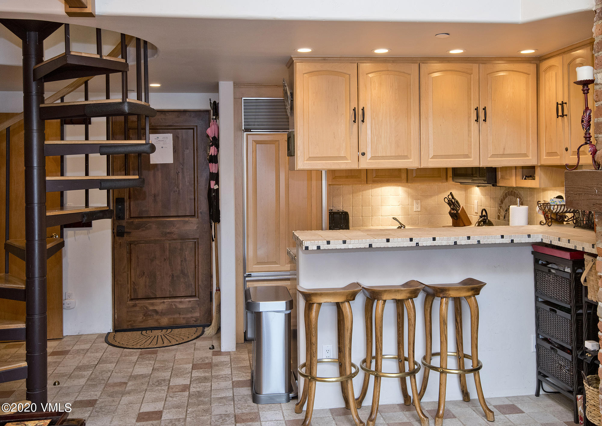 225 Wall Street, Unit 307 Vail, CO 81657 - Photo 9 of 31 a kitchen with a sink refrigerator and cabinets