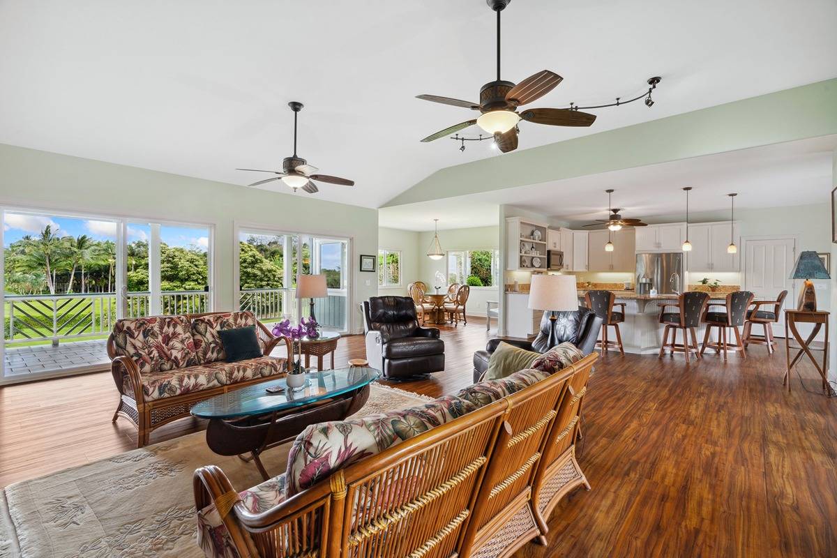 1661 Huli Road Kilauea, HI 96754 - Photo 11 of 28 a living room with lots of furniture and a large window
