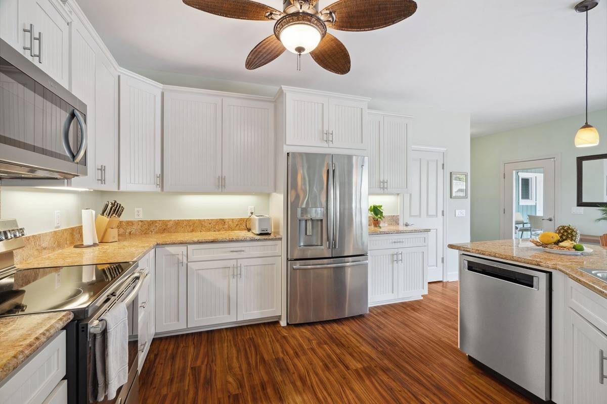 1661 Huli Road Kilauea, HI 96754 - Photo 18 of 28 a kitchen with stainless steel appliances granite countertop a sink refrigerator and microwave