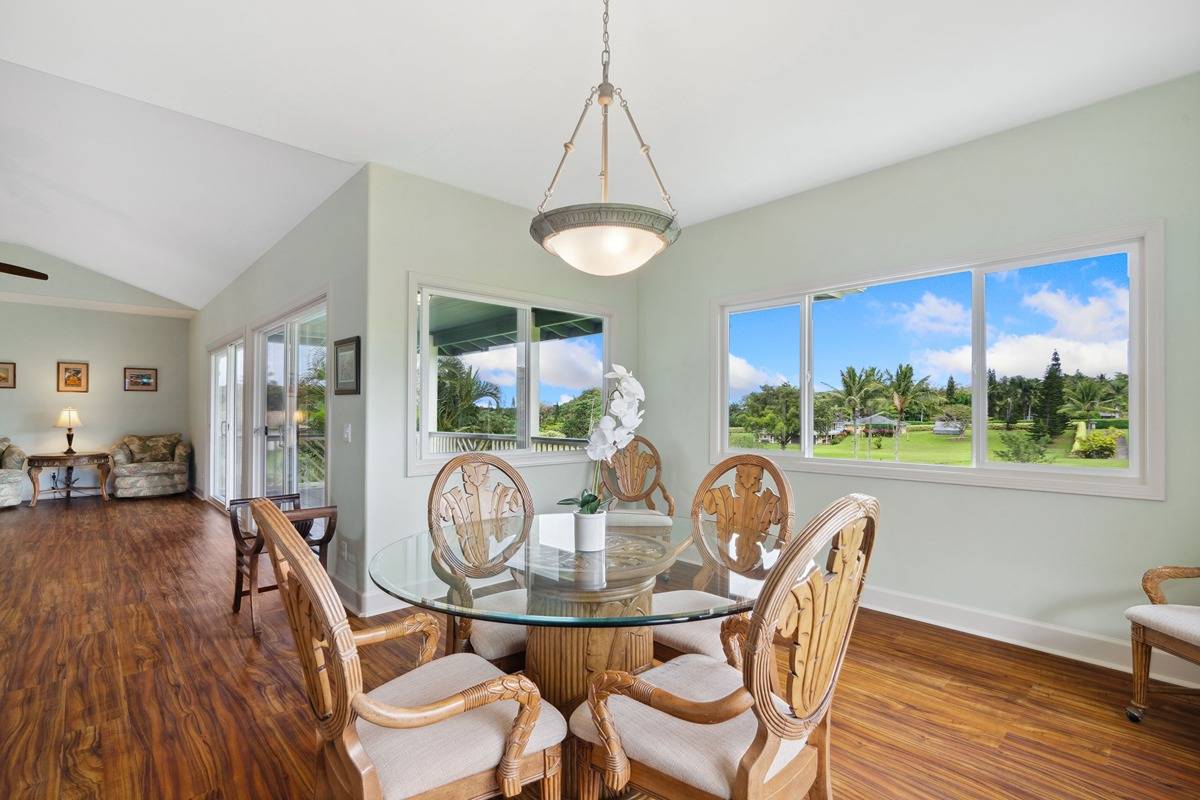 1661 Huli Road Kilauea, HI 96754 - Photo 19 of 28 a dining room with furniture a chandelier and wooden floor