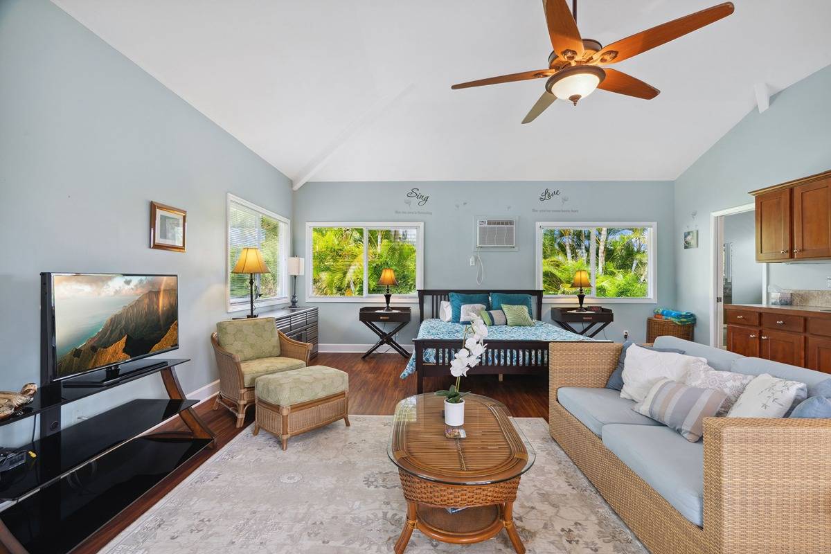 1661 Huli Road Kilauea, HI 96754 - Photo 20 of 28 a living room with furniture and a flat screen tv