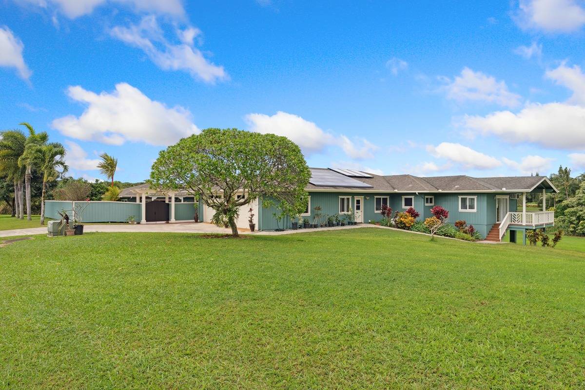 1661 Huli Road Kilauea, HI 96754 - Photo 2 of 28 a front view of a house with a garden