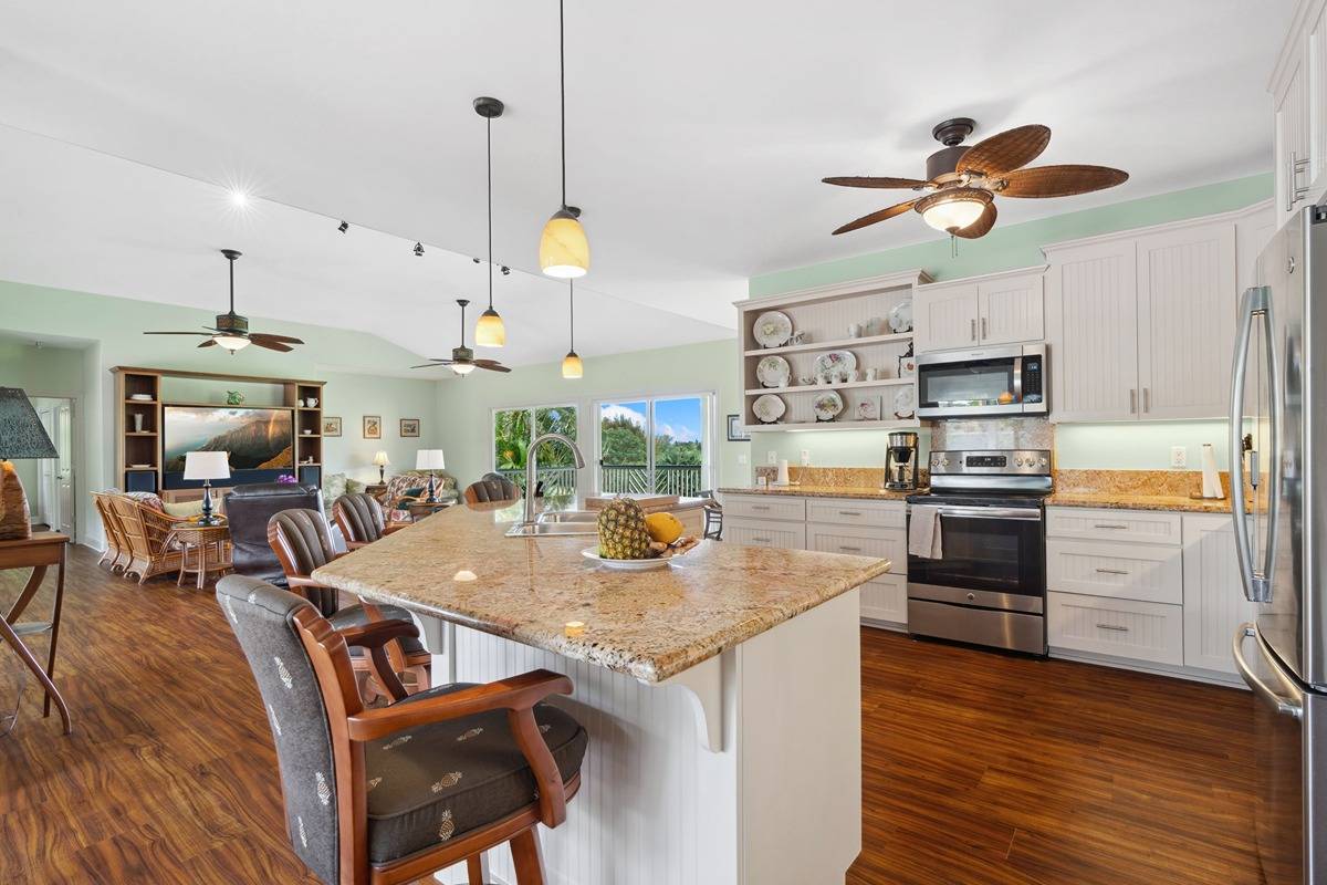 1661 Huli Road Kilauea, HI 96754 - Photo 5 of 28 a kitchen with stainless steel appliances granite countertop a sink a stove and a wooden floors