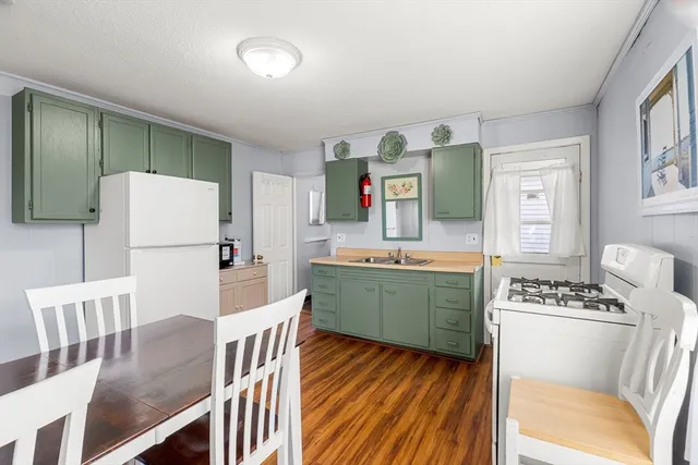 a kitchen with cabinets a counter space and a refrigerator