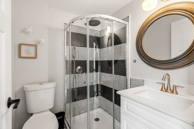 a bathroom with a sink a toilet and a mirror