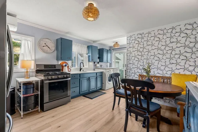 a kitchen with stainless steel appliances a stove a table and chairs