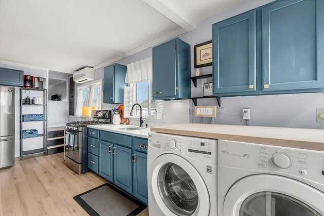 a view of a kitchen with cabinets washer and dryer