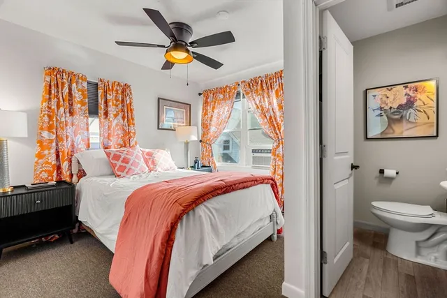 a bedroom with a bed and a painting on the wall