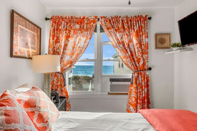 a bedroom with a bed and flat screen tv