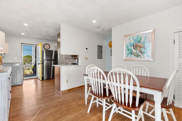 a view of a dining room with furniture and wooden floor