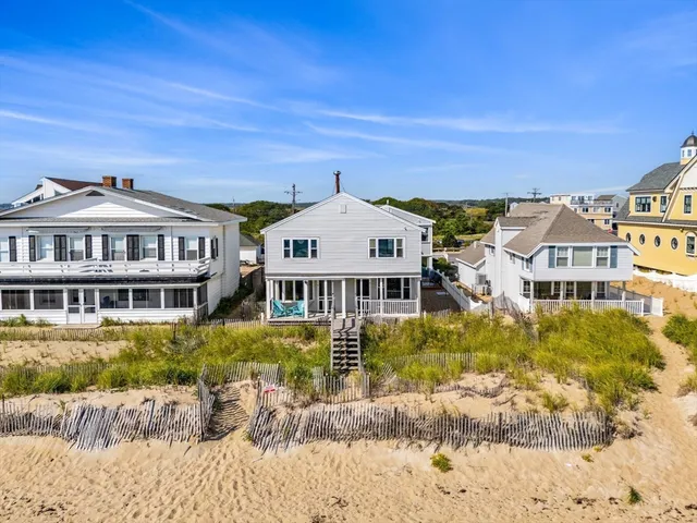 a view of a big house with a big yard and large trees