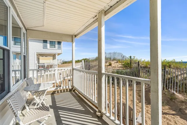 a view of a balcony with wooden floor