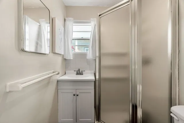 a bathroom with a sink toilet and mirror