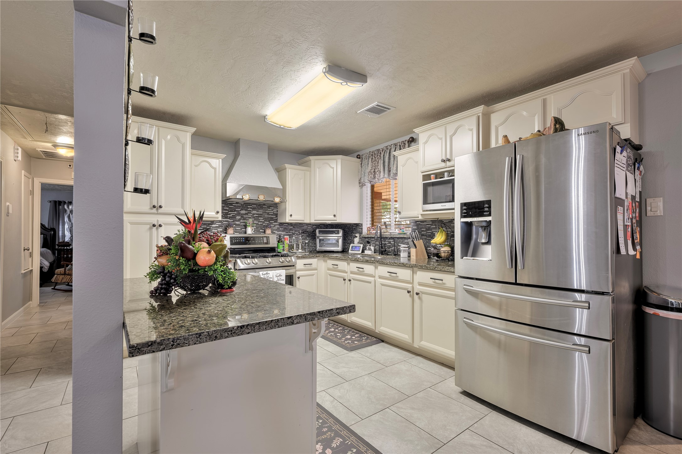 4110 Anice Street Houston, TX 77039 - Photo 13 of 29 a kitchen with refrigerator a sink and cabinets