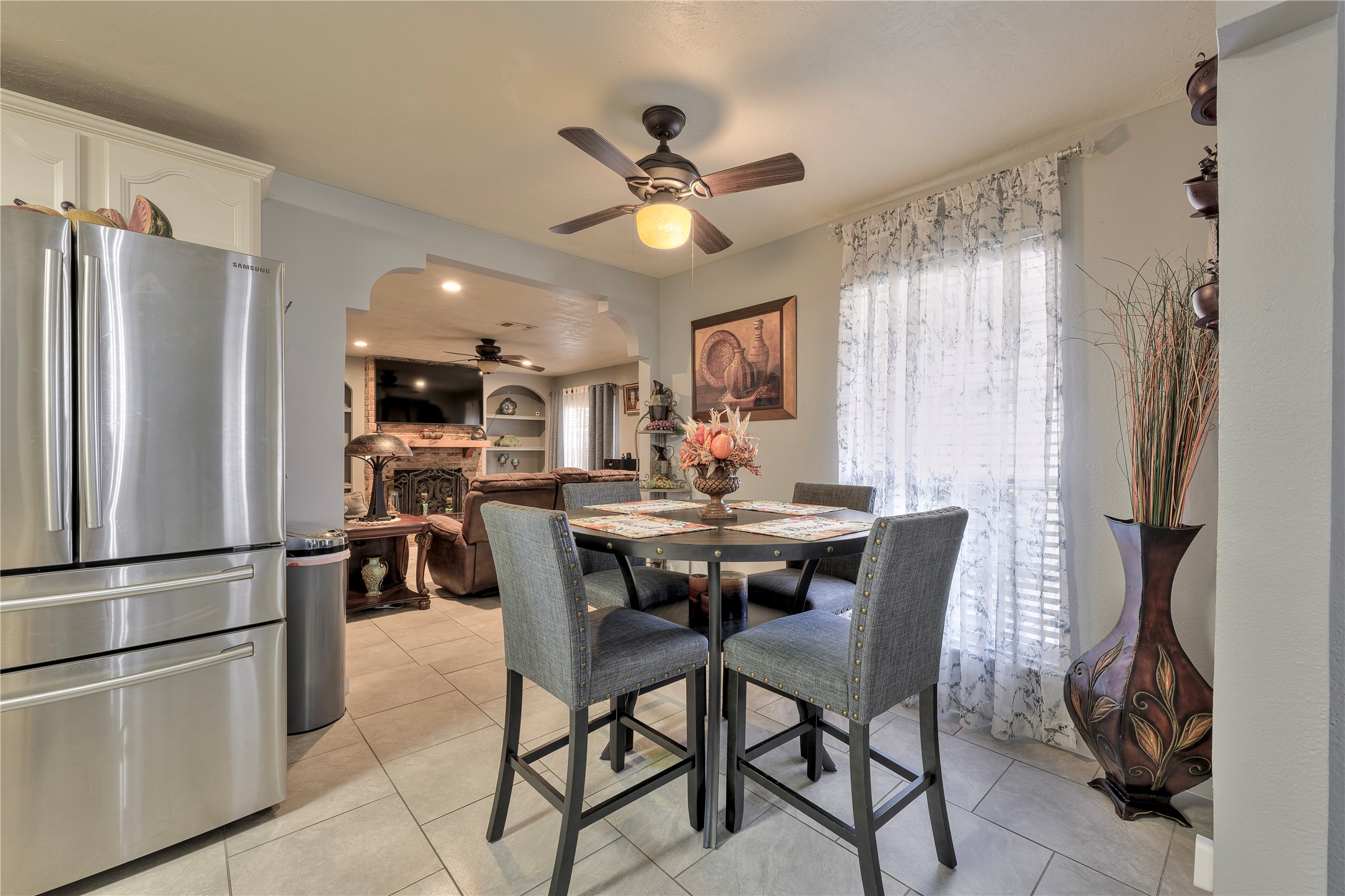 4110 Anice Street Houston, TX 77039 - Photo 14 of 29 a kitchen with stainless steel appliances kitchen island granite countertop a refrigerator a stove a dining table and chairs with wooden floor