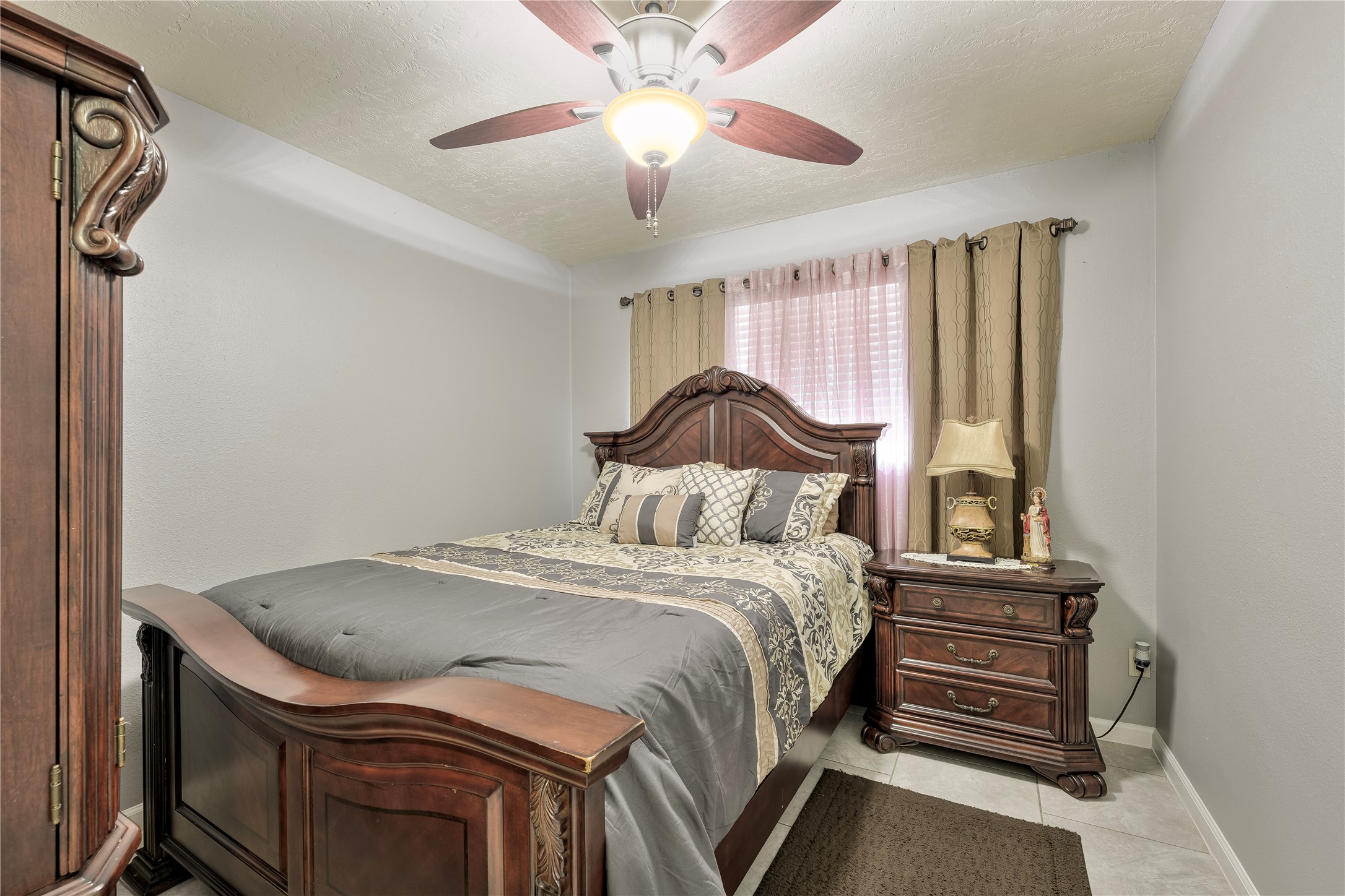 4110 Anice Street Houston, TX 77039 - Photo 20 of 29 a bedroom with a bed and a chandelier