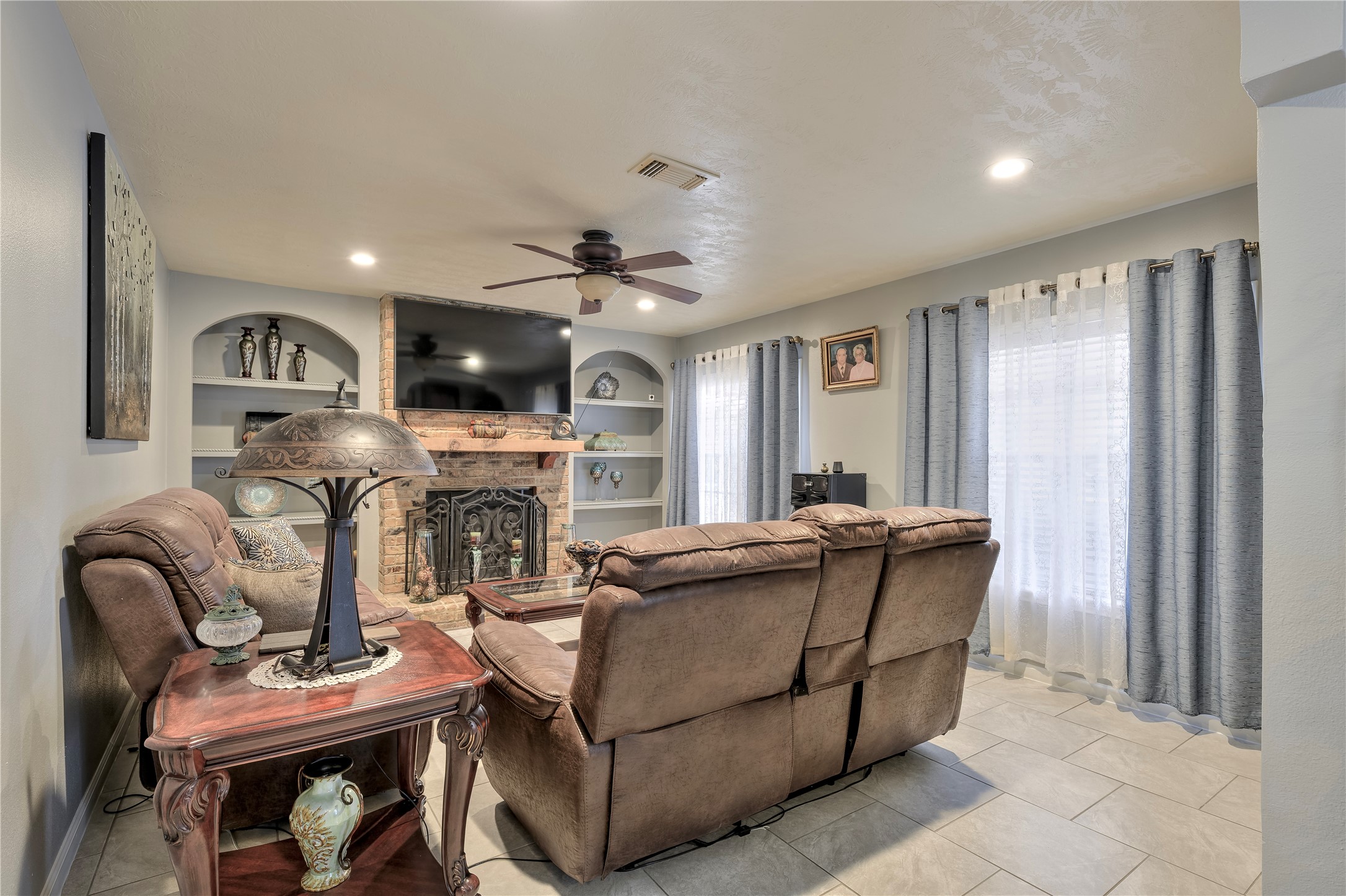 4110 Anice Street Houston, TX 77039 - Photo 8 of 29 a living room with furniture a fireplace and a flat screen tv